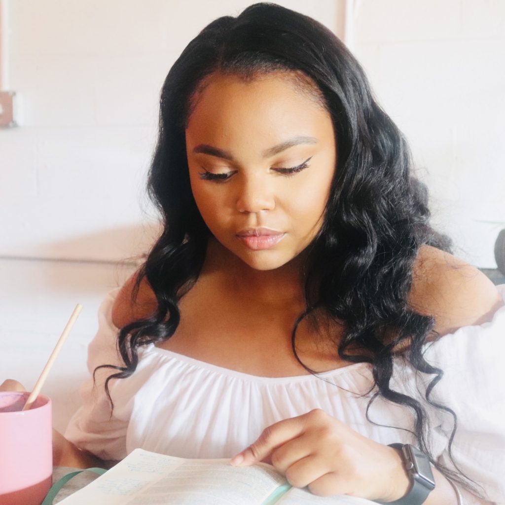 Young woman studying her Bible at coffee shop